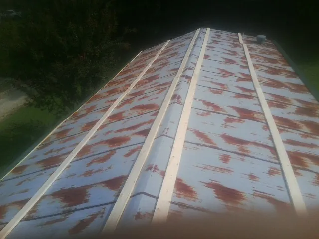 Rusted metal roof panels with new wood purlins before replacement — Storm Damage Roof Repair in Suncook by Roofing Brothers