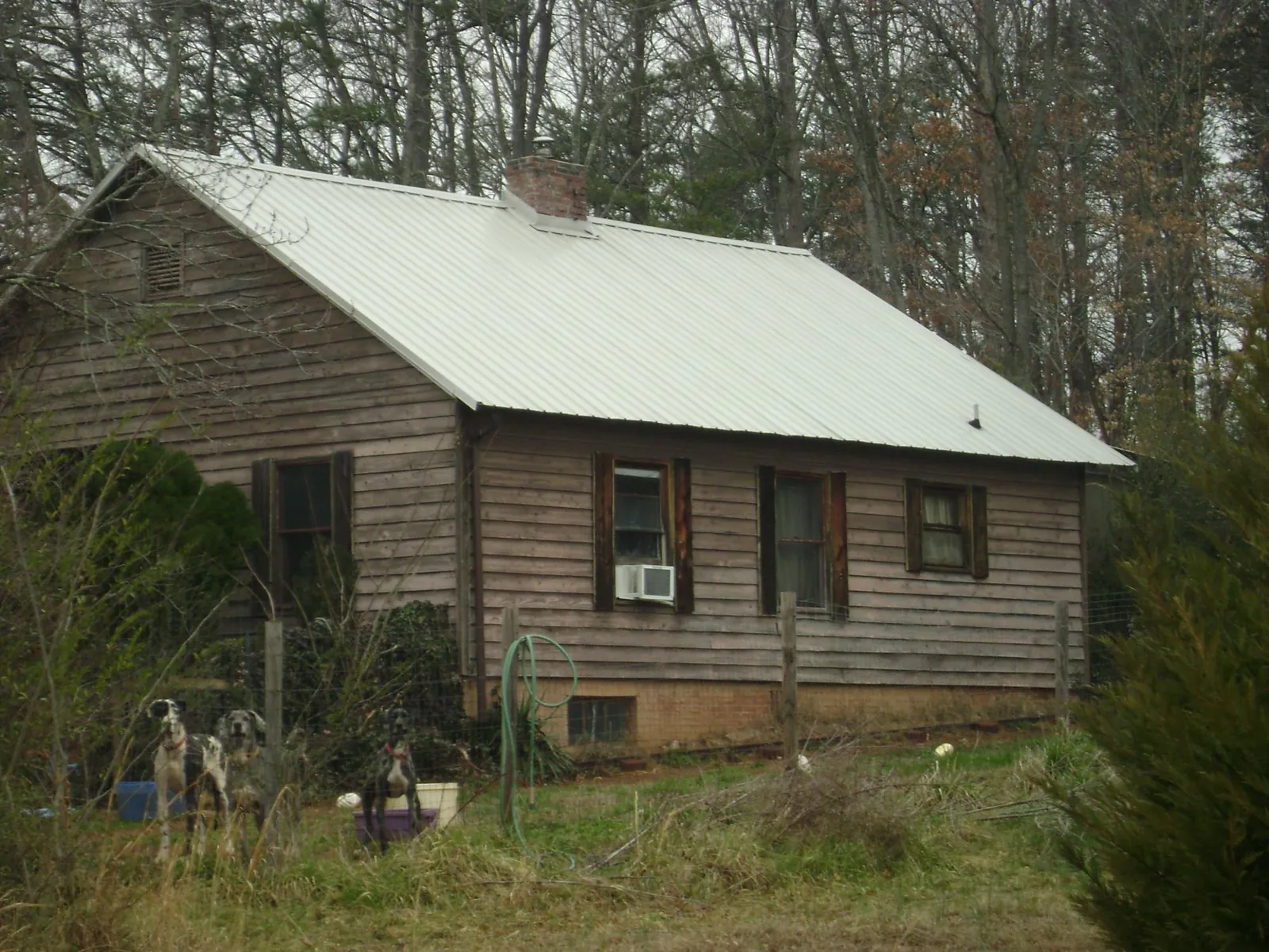 White metal roof on an old wood sided farmhouse, from a Metal Roof Installation job in Suncook